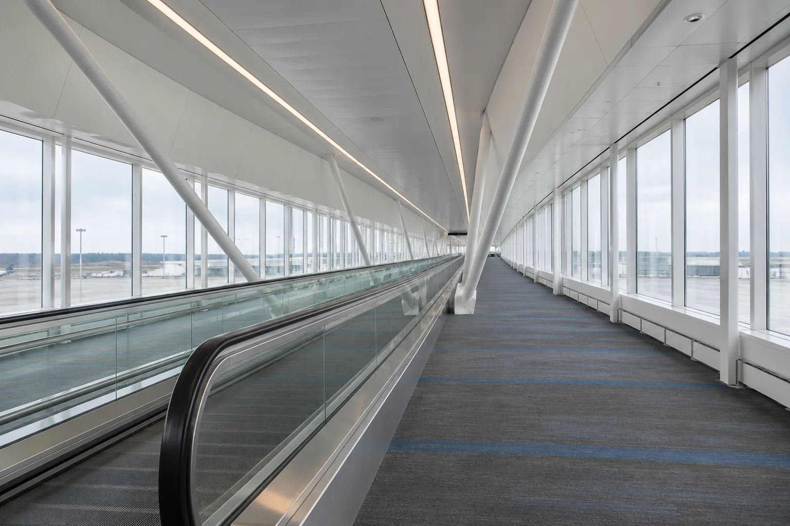 The long glass-sided moving walkway corridor at Seattle-Tacoma airport.