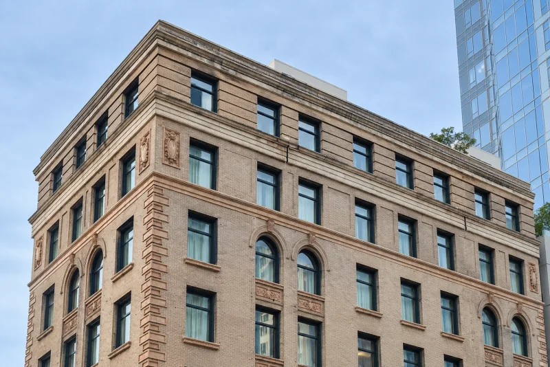 The upper floors of the State Hotel, a brick and stone building in downtown Seattle.