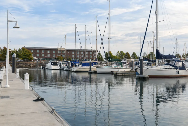 Sailboats and motor yachts moored at floating docks in the Port of Everett marina.