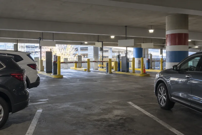 A lane of reserved parking between parked cars and painted columns inside the garage at Seattle-Tacoma airport.