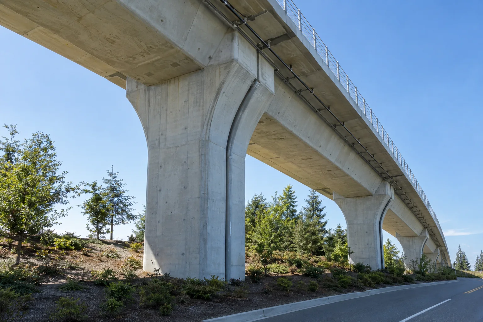 A concrete pier holding up the elevated light rail guideway near Seattle-Tacoma airport, seen from below.