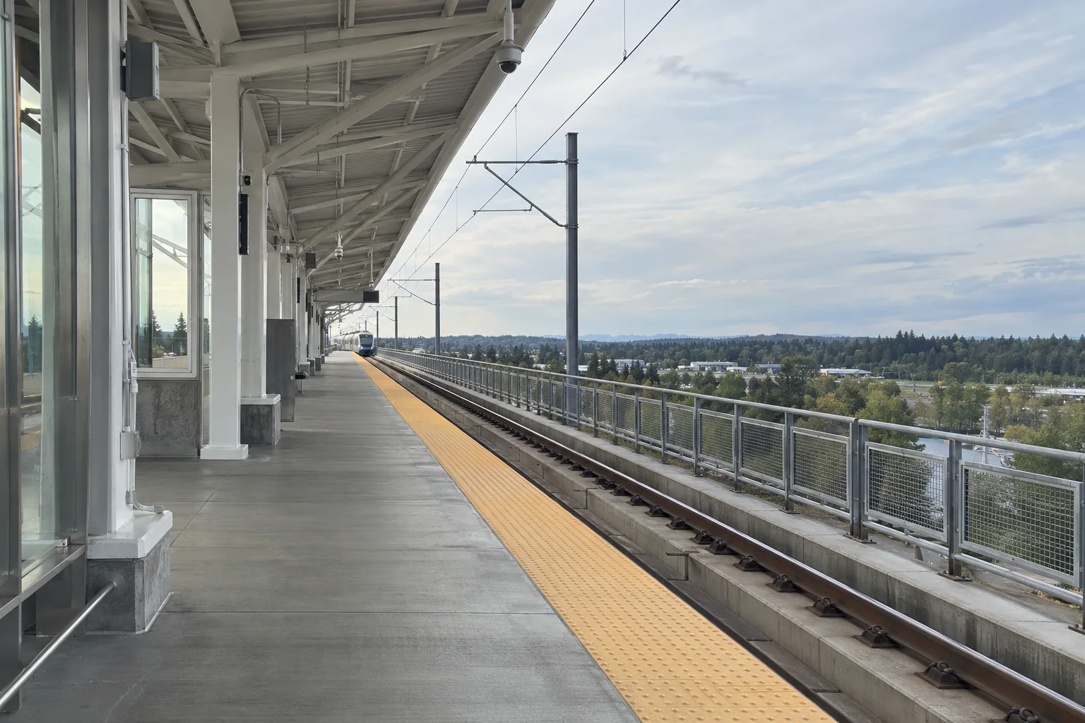 The elevated Link light rail platform at SeaTac/Airport station under a white steel canopy.
