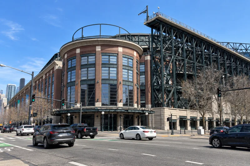 The curved brick rotunda corner and steel truss tower of T-Mobile Park, seen from across the street in Seattle.