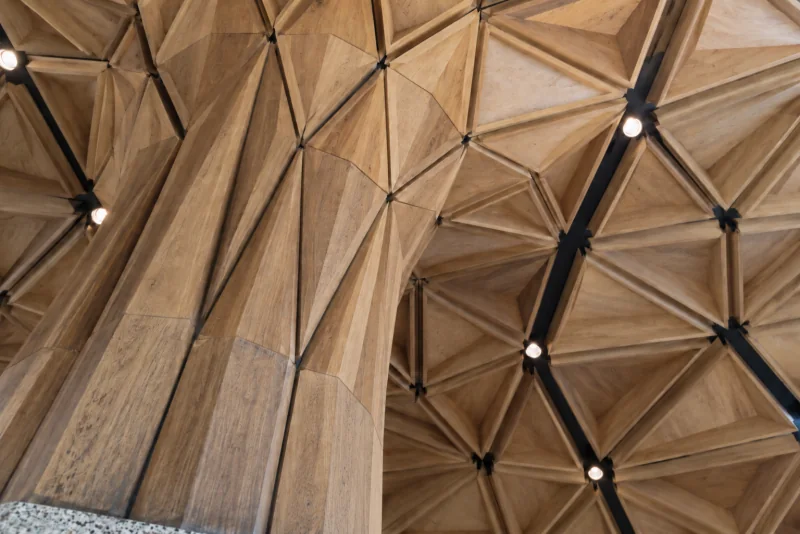 The branching timber column flaring into the faceted timber ceiling of the Central Terminal at Seattle-Tacoma airport.