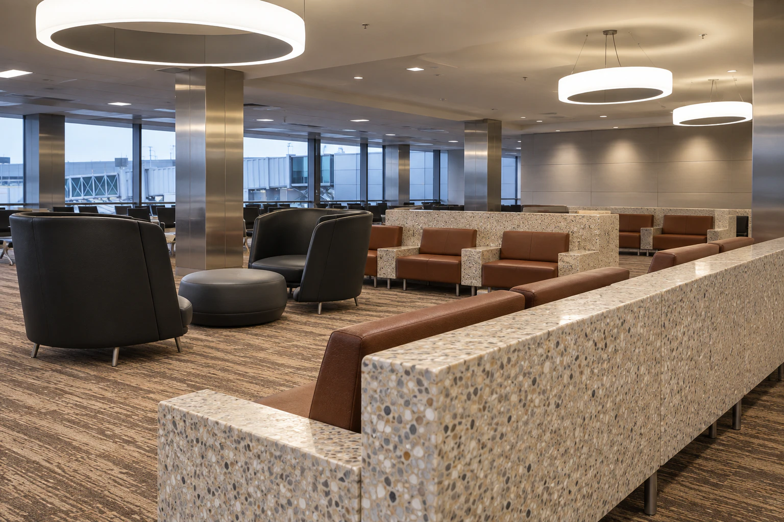 Circular ceiling lights and lounge seating inside SEA’s existing S Concourse