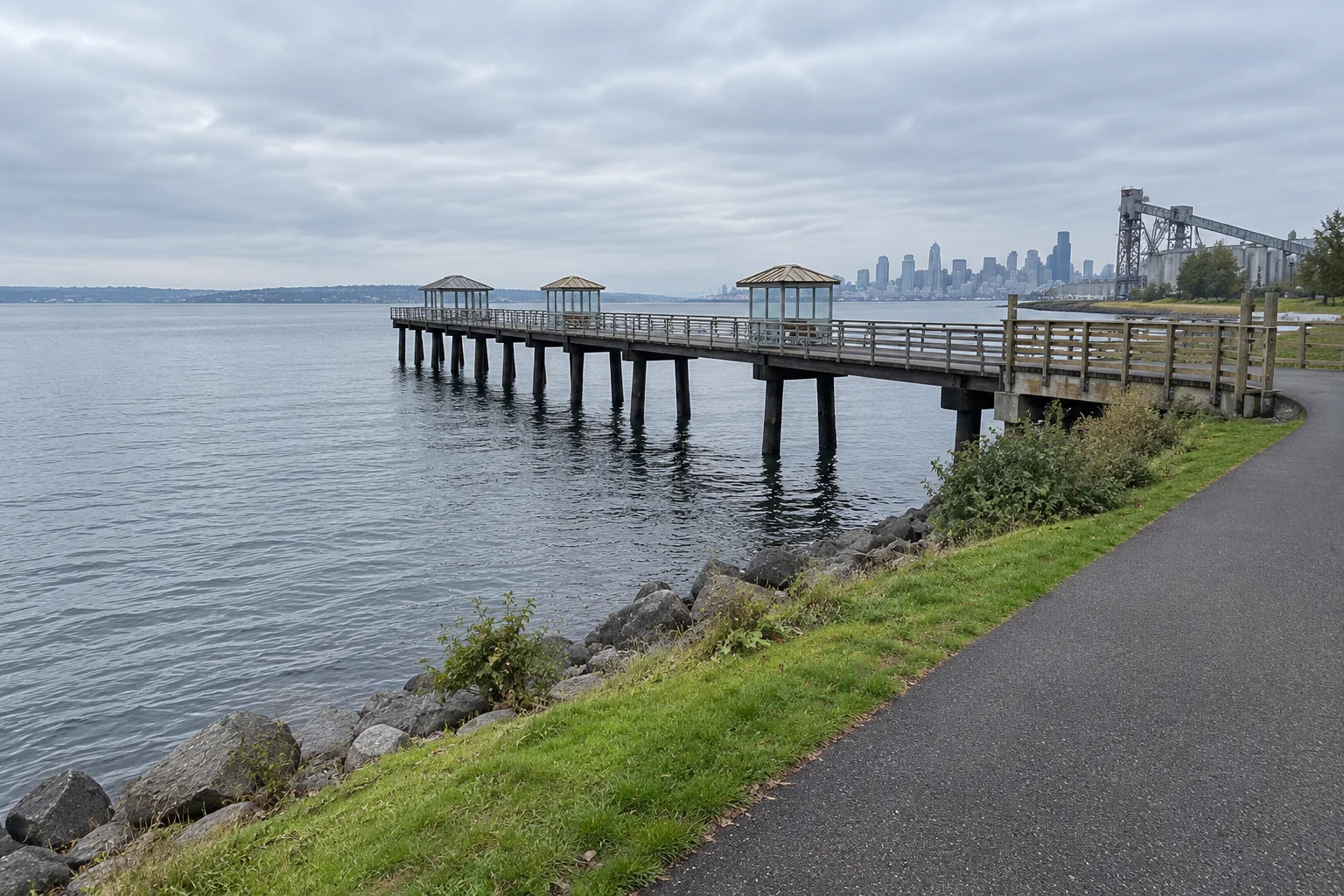 The Elliott Bay Trail and a fishing pier at Smith Cove with the Seattle skyline across the water.