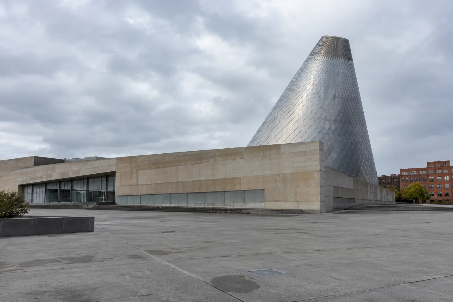 The Museum of Glass in Tacoma with its slanted steel cone, seen across the plaza.