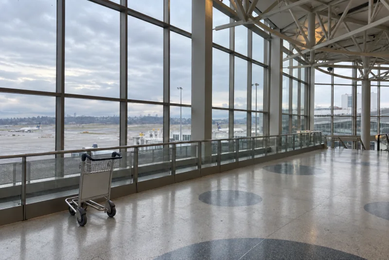 A raised view of the Central Terminal's glass wall and patterned terrazzo floor at Seattle-Tacoma airport.