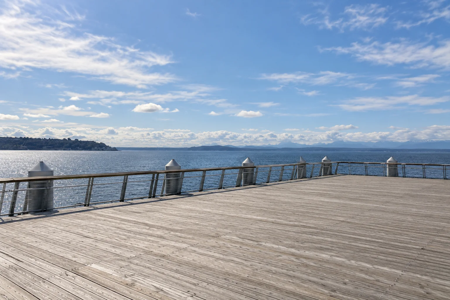 The wide timber deck of Pier 62 on Elliott Bay in Seattle.